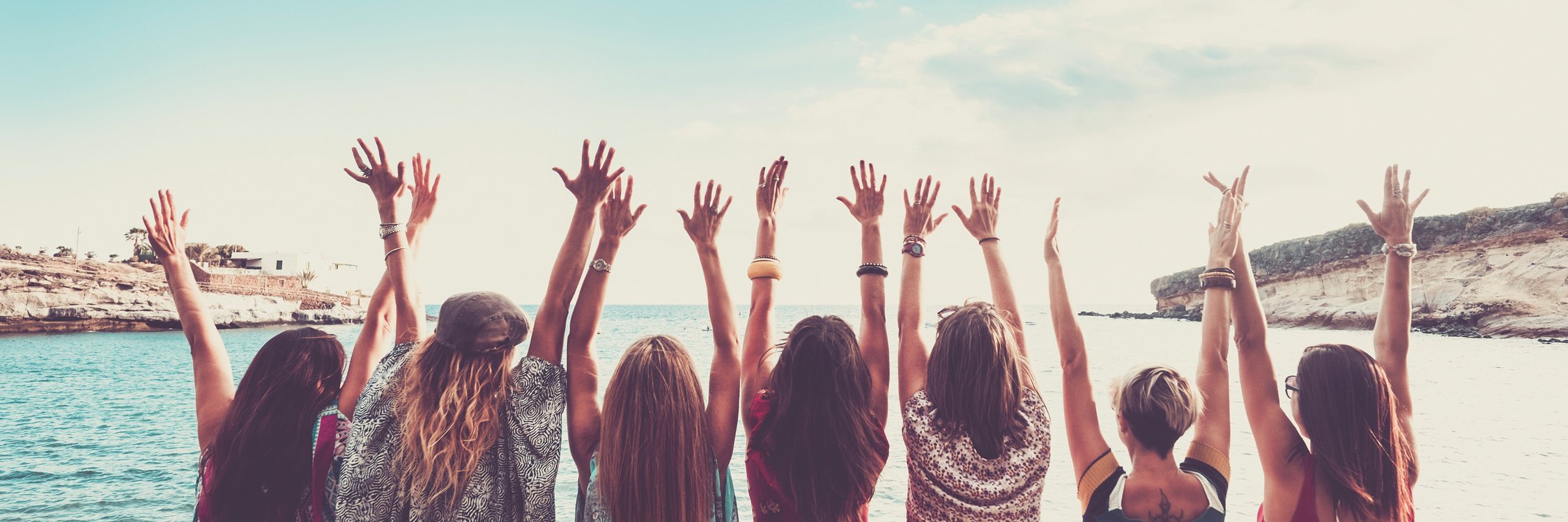 Group of Women Viewed from Back with Arms up for Happiness in Fr